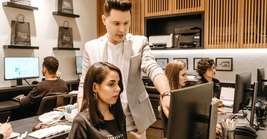 Management - Man Teaching Woman in Front of Monitor