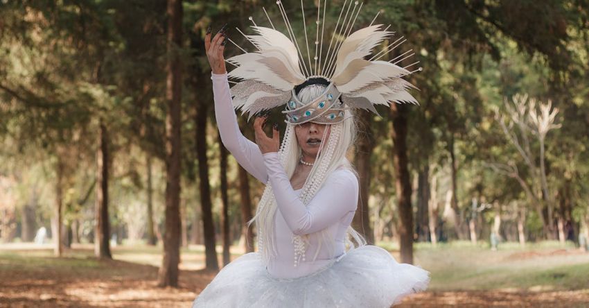 Practices - A young woman in a white tutu and feathers