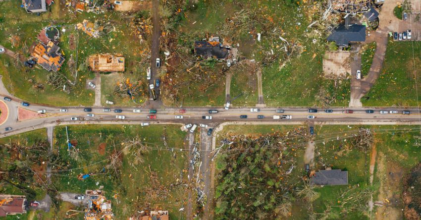 Outcomes - Aerial view of village houses ruined by wild storm near windthrown trees and electricity lines