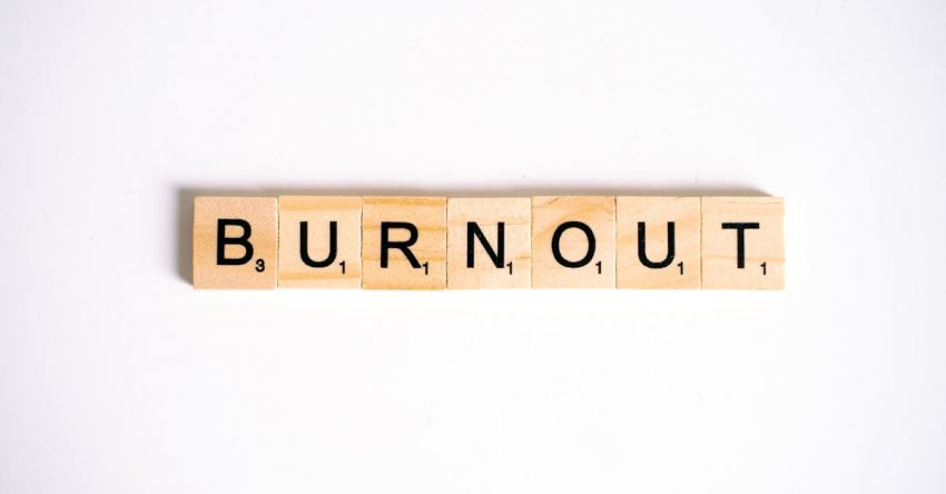 Burnout - Close-Up Shot of Scrabble Tiles on a White Surface